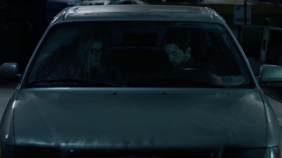 Alice talks to the vampire in the front of his car.