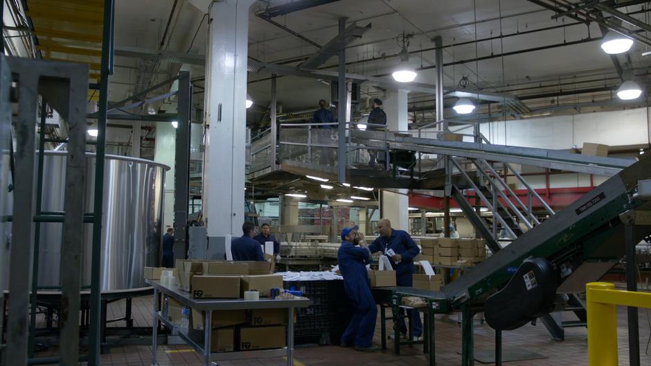 Clint Hicks talks to his coworker about the Hawks while they work at the packaging area.