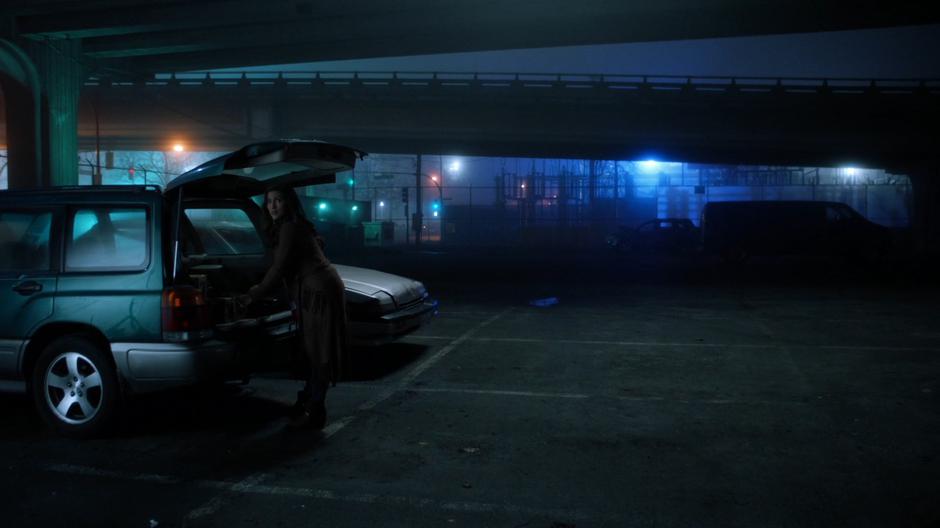 Izzy Bowin looks over as she is packing the trunk of her car and sees Barry, Ralph, and Cisco approaching.