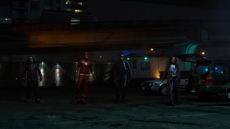 Cisco, Barry, Ralph, and Izzy Bowin watch as DeVoe is rescued by his wife.