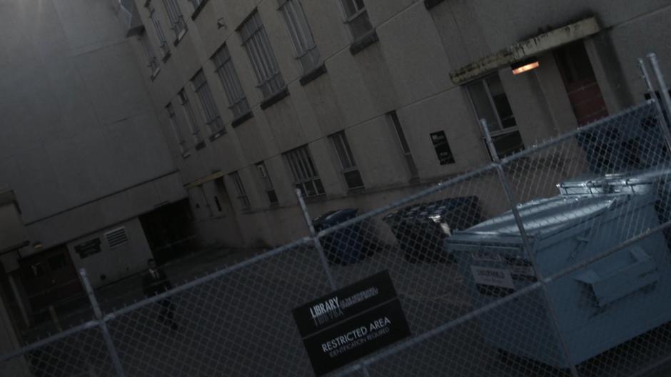 Penny runs towards the fence outside the Library.