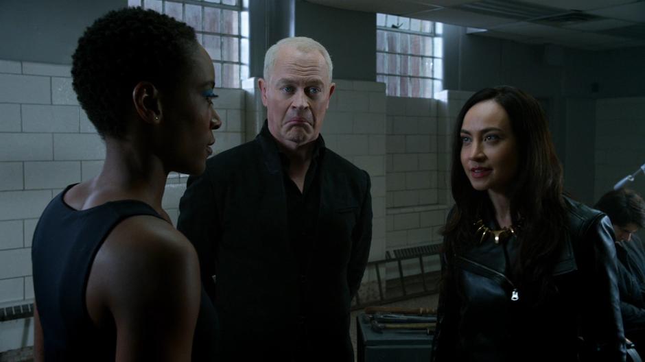 Darhk makes a funny face as Kuasa and Nora discuss their totems.