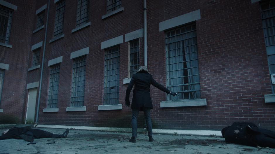 Damian Darhk shoots the two guards outside the safe house.