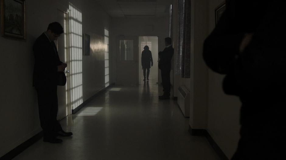 Young Darhk walks into the hallway lined with several guards.