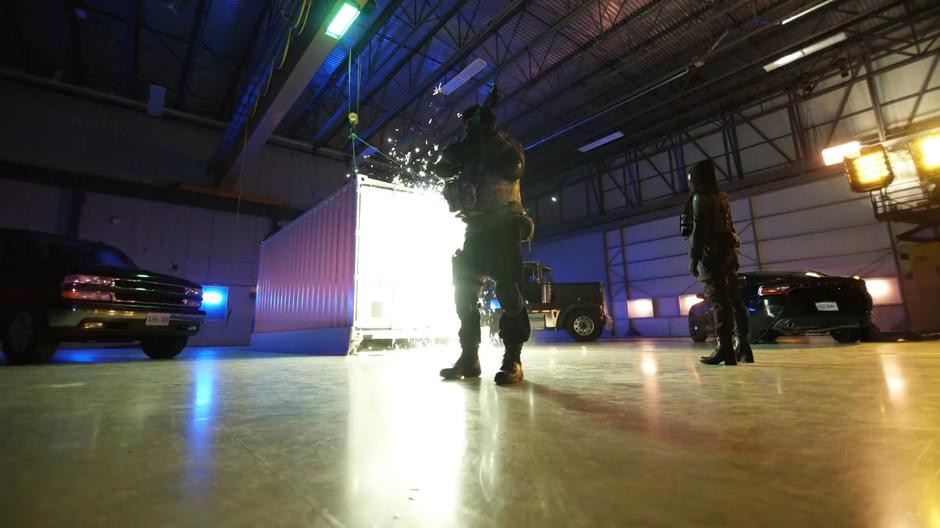 Veronica Dale watches as the shipping container is blasted open.