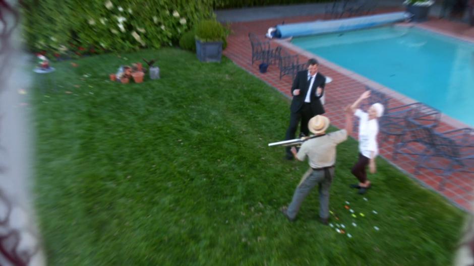 The driver, gardener, and chef high five after breaking some pots with the golfball gun.