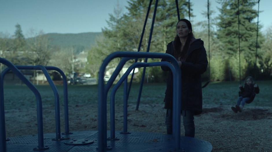 Diana Eggers looks around for her son while Emily Strong swings on the swings.