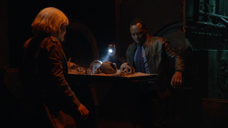 Clive pulls out the tray from the incinerator revealing several smashed in skulls to him and Liv.