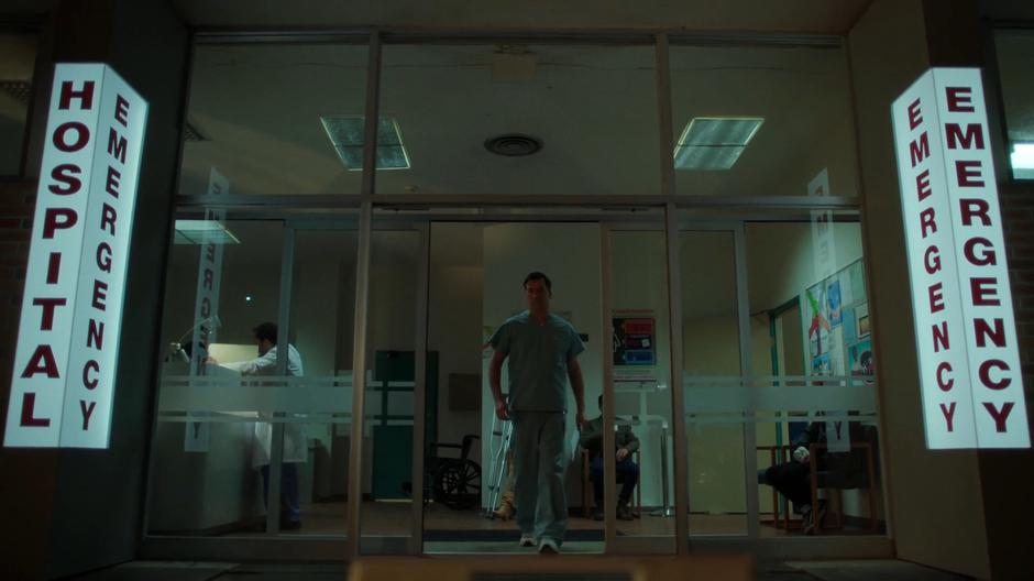 A emergecy room nurse walks out towards the cooler.