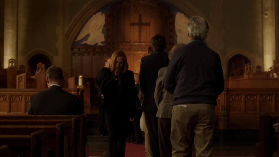 Scully walks down the aisle after taking communion.