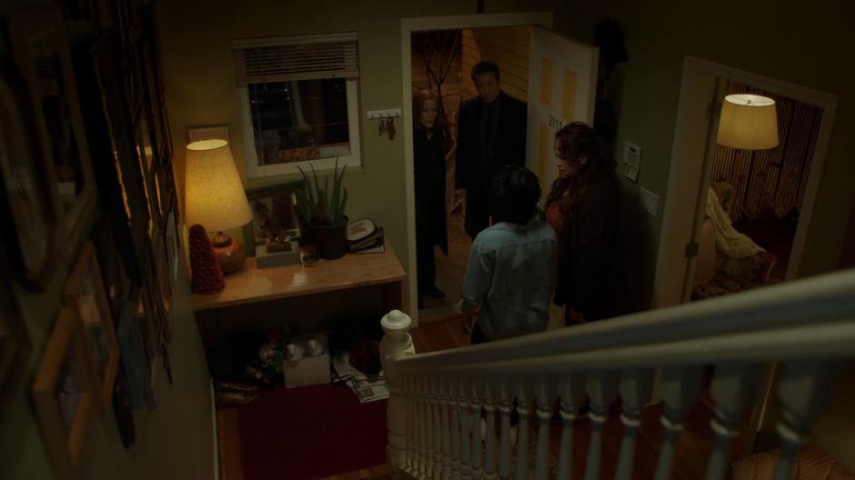 Juliet Bocanegra walks up to where her mother is talking with Scully and Mulder at the door.