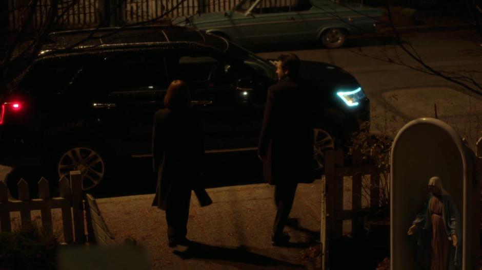 Scully and Mulder walk away to their car.