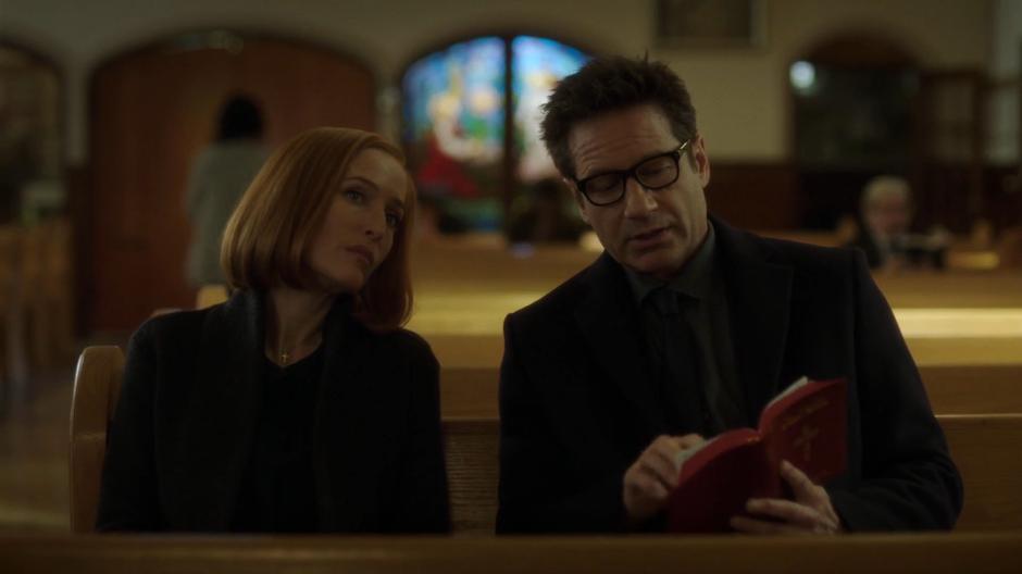 Mulder shows Scully the passage from the bible that was written on the cooler.