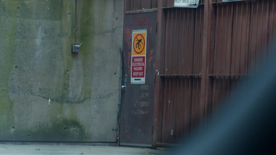 The door to the incinerator building is visible down the alley.