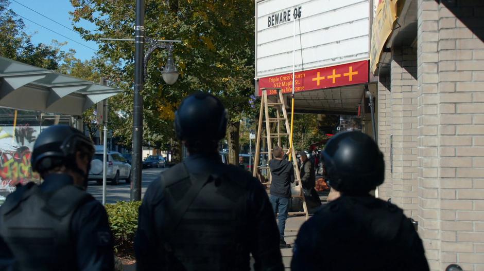 Major's team spots Tucker changing the marquee outside the church.