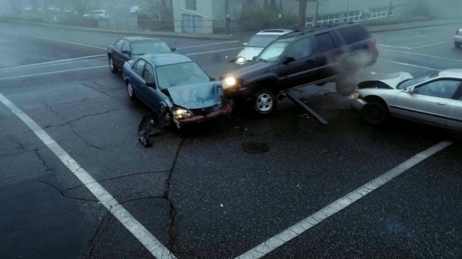 Several more cars crash into one another in the middle of the intersection.