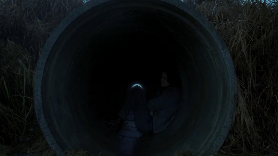 William hides inside a drainage pipe beneath the highway.
