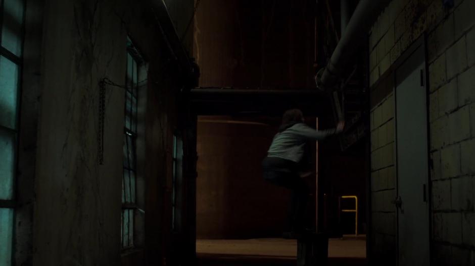 William leaps up onto a exterior staircase.