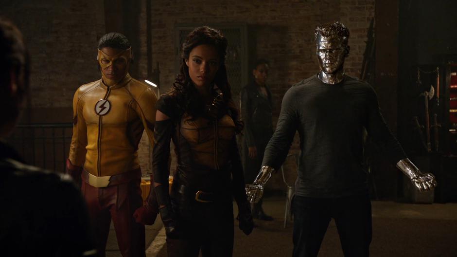 Wally, Amaya, and Nate face off against Nora fully suited up while Kuasa watches from behind them.