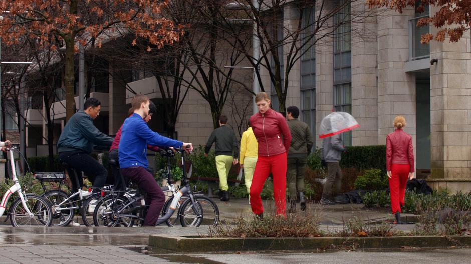 Two Avas in red outfits direct bicycle traffic.