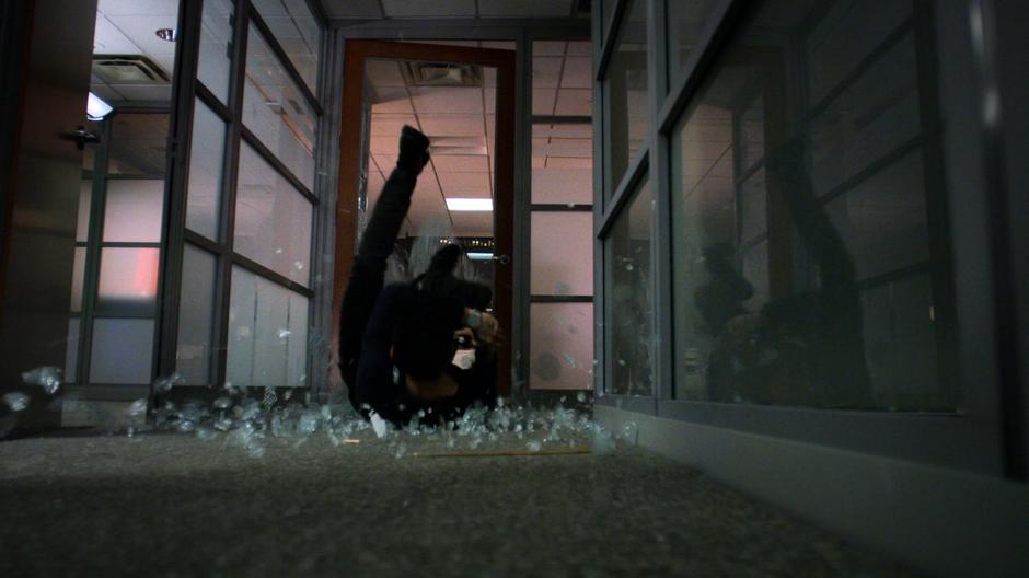 Pryce is thrown through the glass door of his office by Jessica.