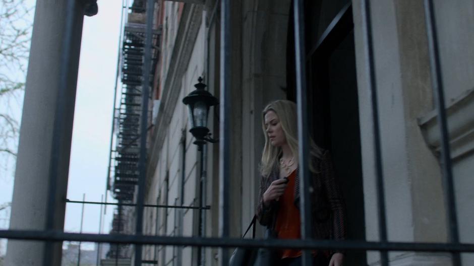 Trish walks out of Jessica's building.