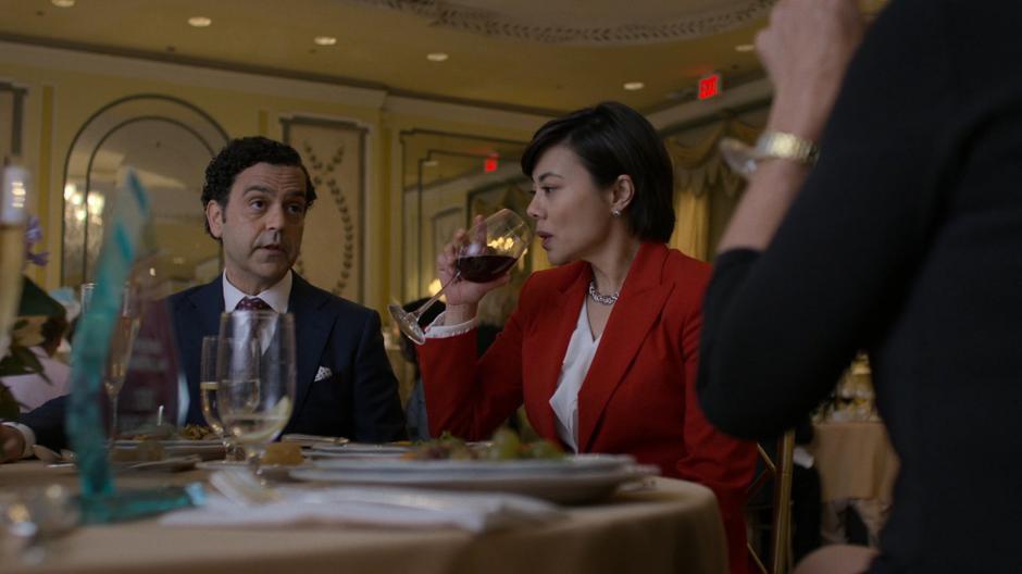 Steven Benowitz talks to Hogarth as Linda Chao takes a drink from her wine.
