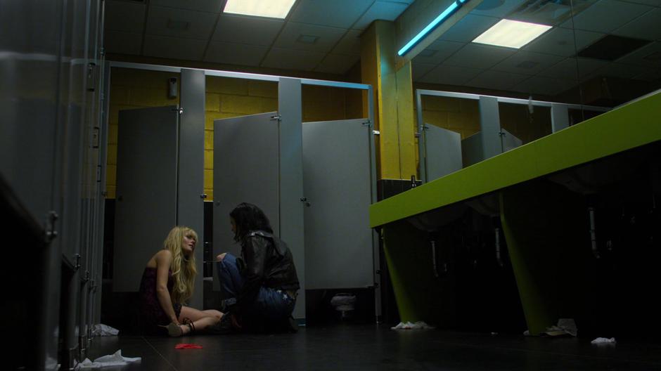 Jessica kneels down on the bathroom floor with Trish.