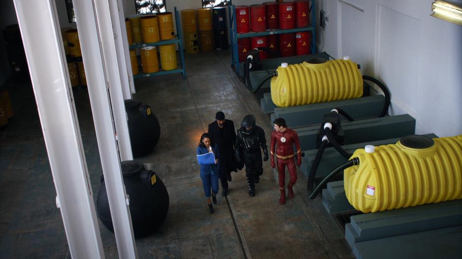 Iris, Joe, and Barry escort Neil Borman to the truck in a hazmat suit.