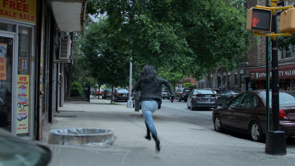 Jessica runs down the street as the car pulls away.