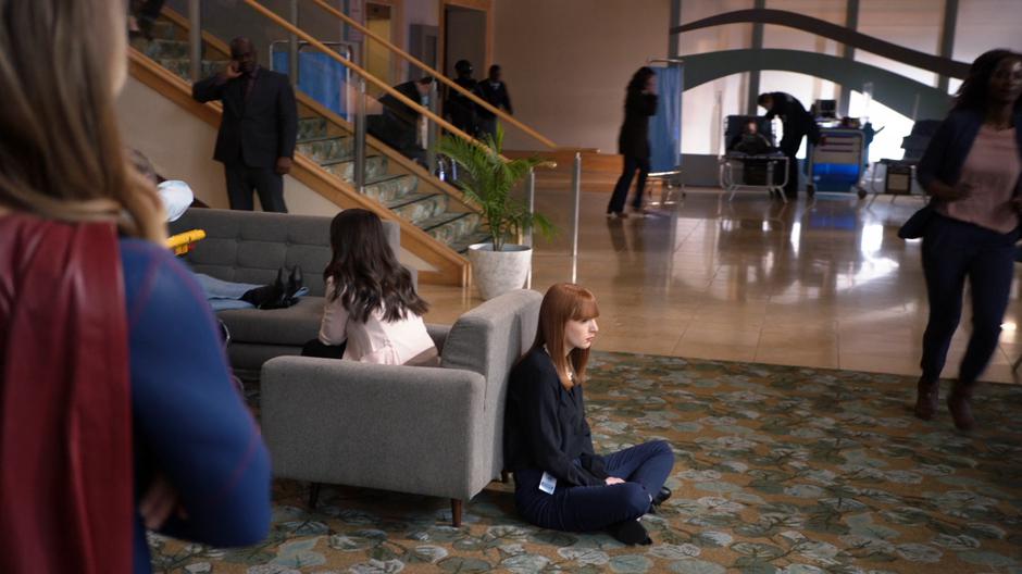 Kara sees Adelaide sitting alone on the ground.