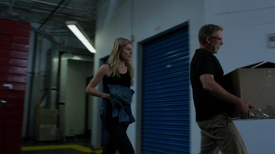 Trish escorts Malus back to the car at gunpoint.