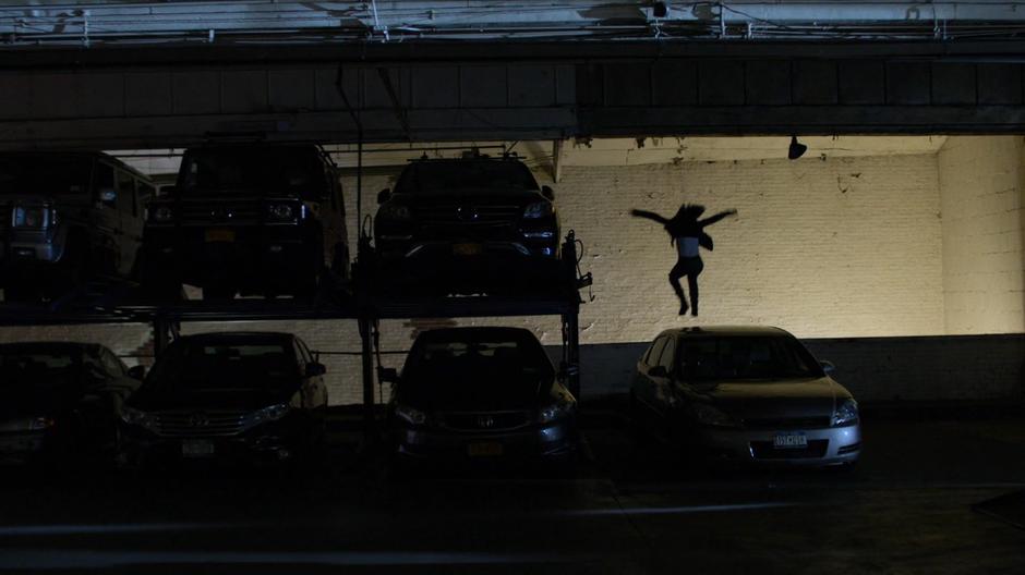 Jessica leaps down onto the ramp to catch Trish's car.