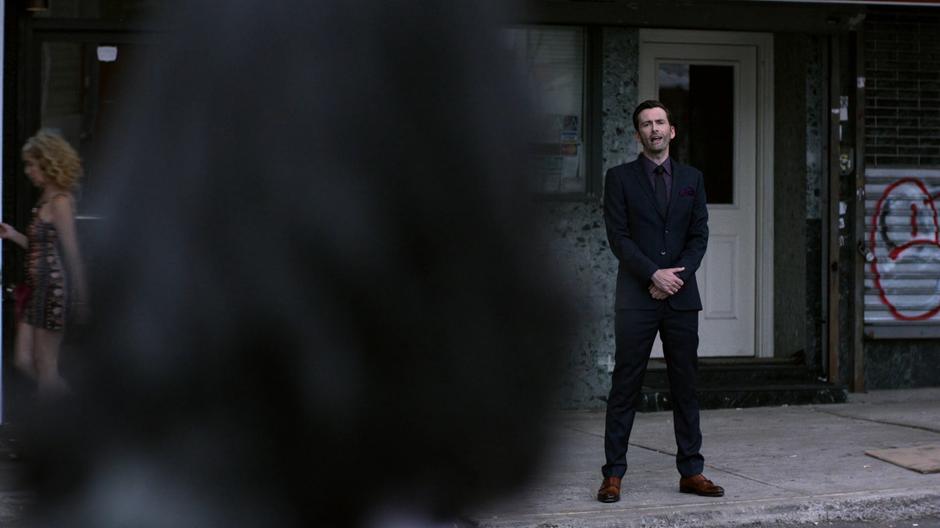 One of the visions of Kilgrave stands across the street taunting Jessica.