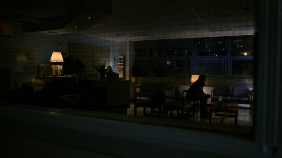 Jessica sits alone in the darkened waiting room.