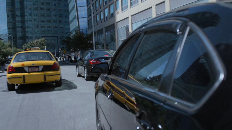 The detectives' car weaves through traffic.