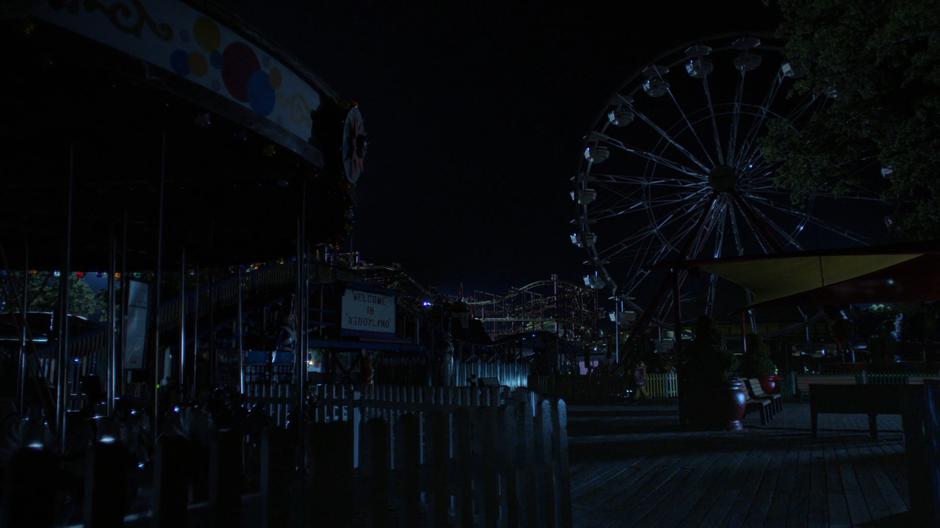 Establishing shot of the darkened amusement park.