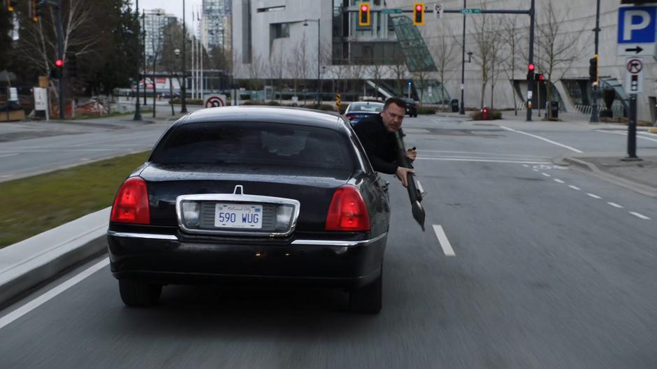 One of the cultists learns out of the car's window with an RPG.