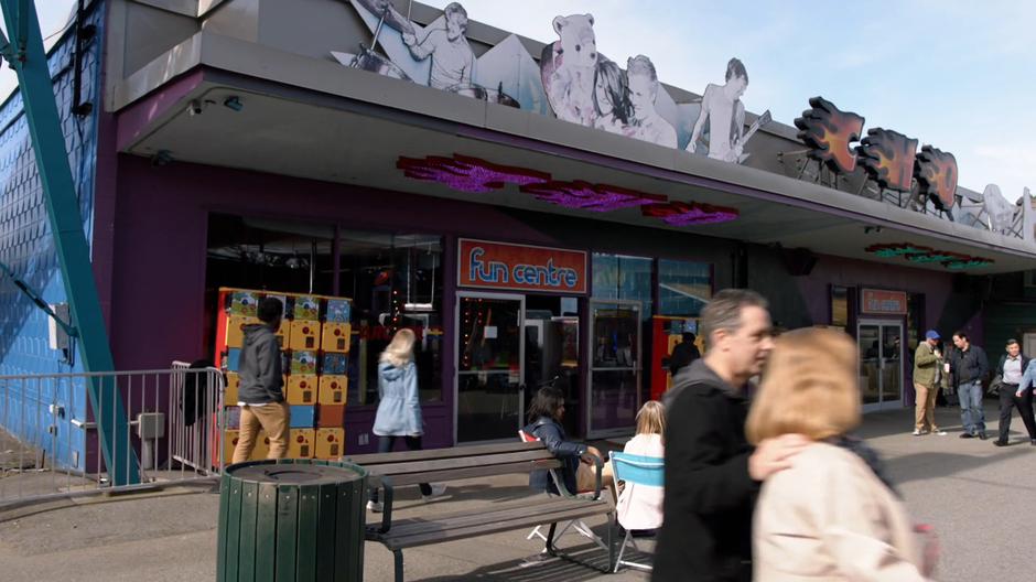 The arcade appears through the crowd.