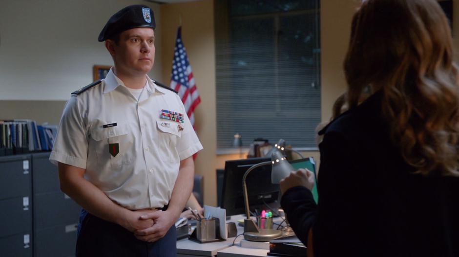 A administrative soldier listens to Liv's rant.
