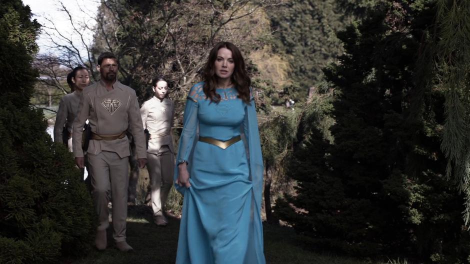 Alura walks into the clearing with some guards.