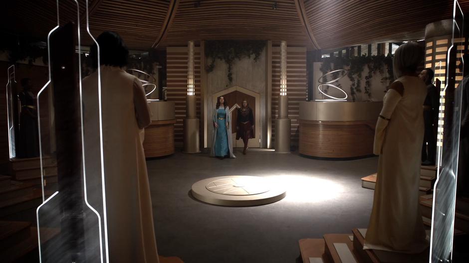 Alura and Kara walk into the council chamber.