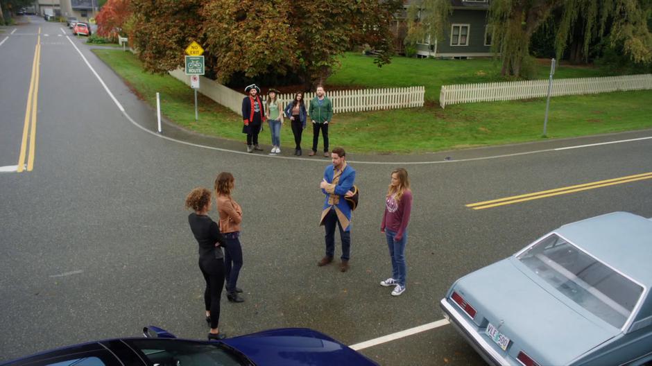 Kylie and Izzy stand across from Jack and Emma while Dave, Carmen, Nina, and Shaun watch the drama from across the street.