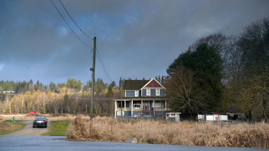 A mysterious car pulls up beside the safe house.