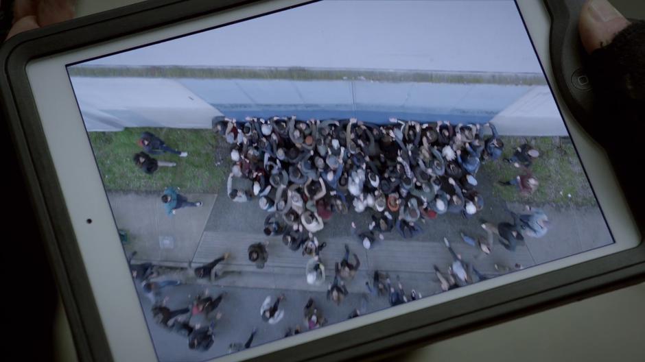 Drone footage shows the angry crowd gathering outside and banging on the door.