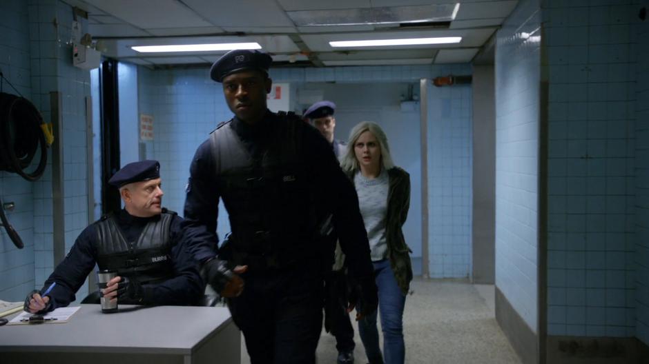Justin leads the way as another solider drags Liv to the interrogation room.