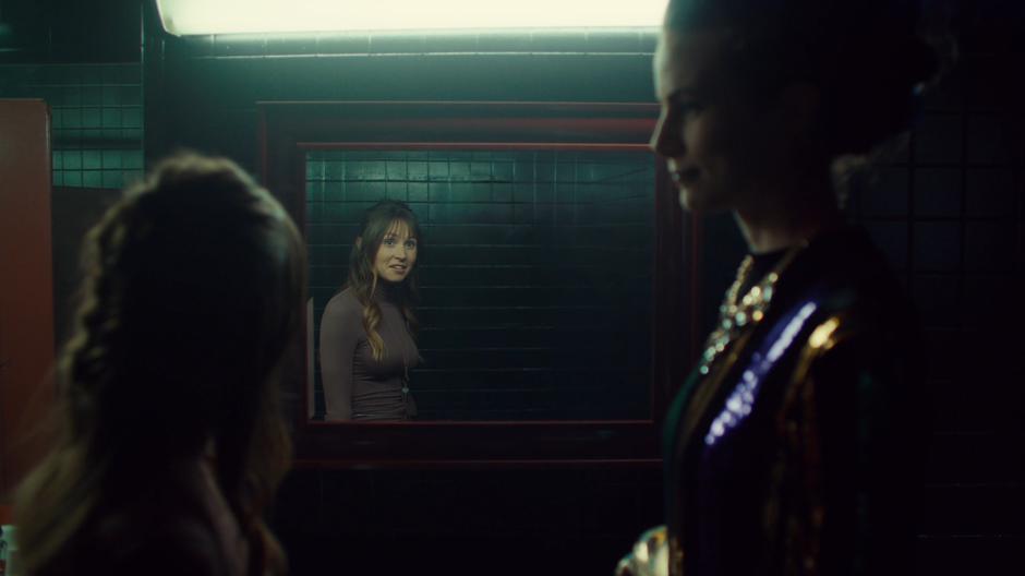 Waverly looks in the mirror at Petra's lack of reflection.