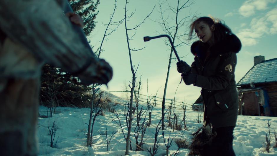Wynonna brandishes her tire iron at the Revenant outside the cabin.