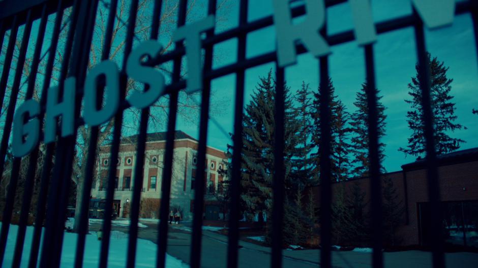 Establishing shot of the exterior of the facility through the front gate.