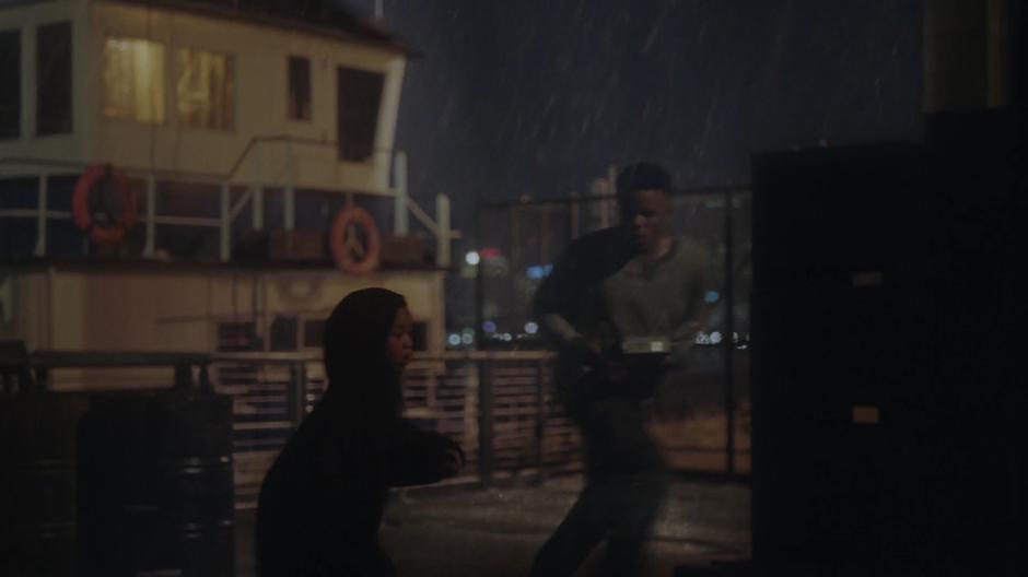Young Tyrone and Billy run behind a shipping container.